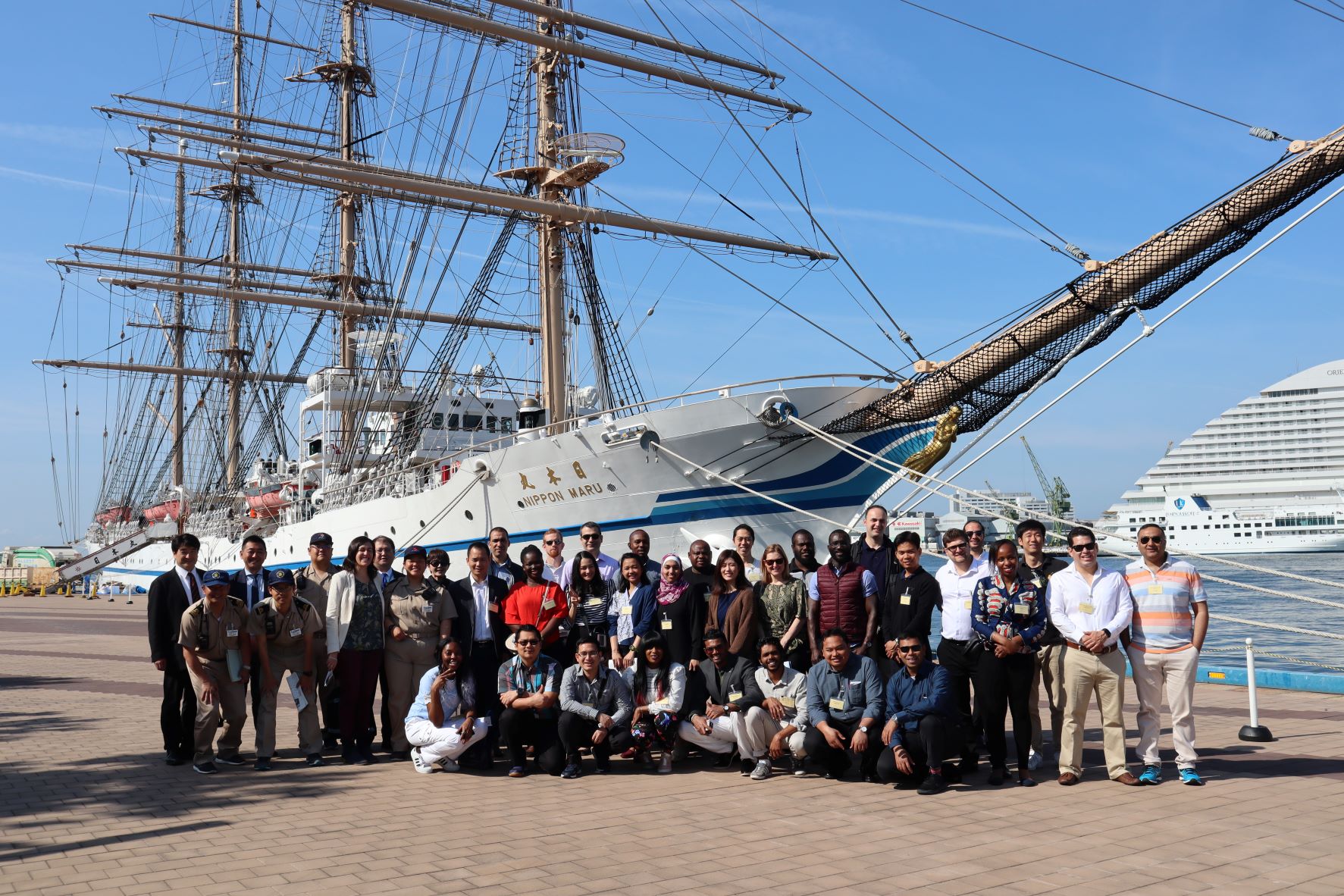 WMU Sasakawa Scholarship students pose for a commemorative photo in front of the Nippon Maru training ship at Kobe Port during the 2019 training in Japan