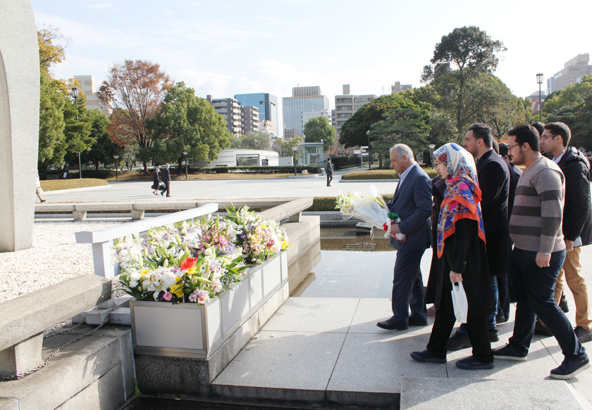 Dr. Dehshiri and students lay flowers at Hiroshima Peace Memorial Park