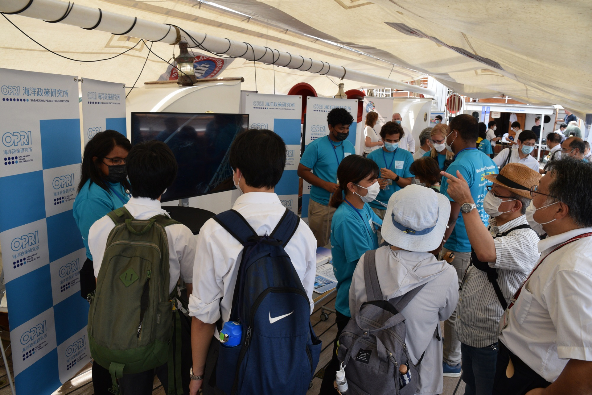 Voyage members explaining their research and studies during the voyage