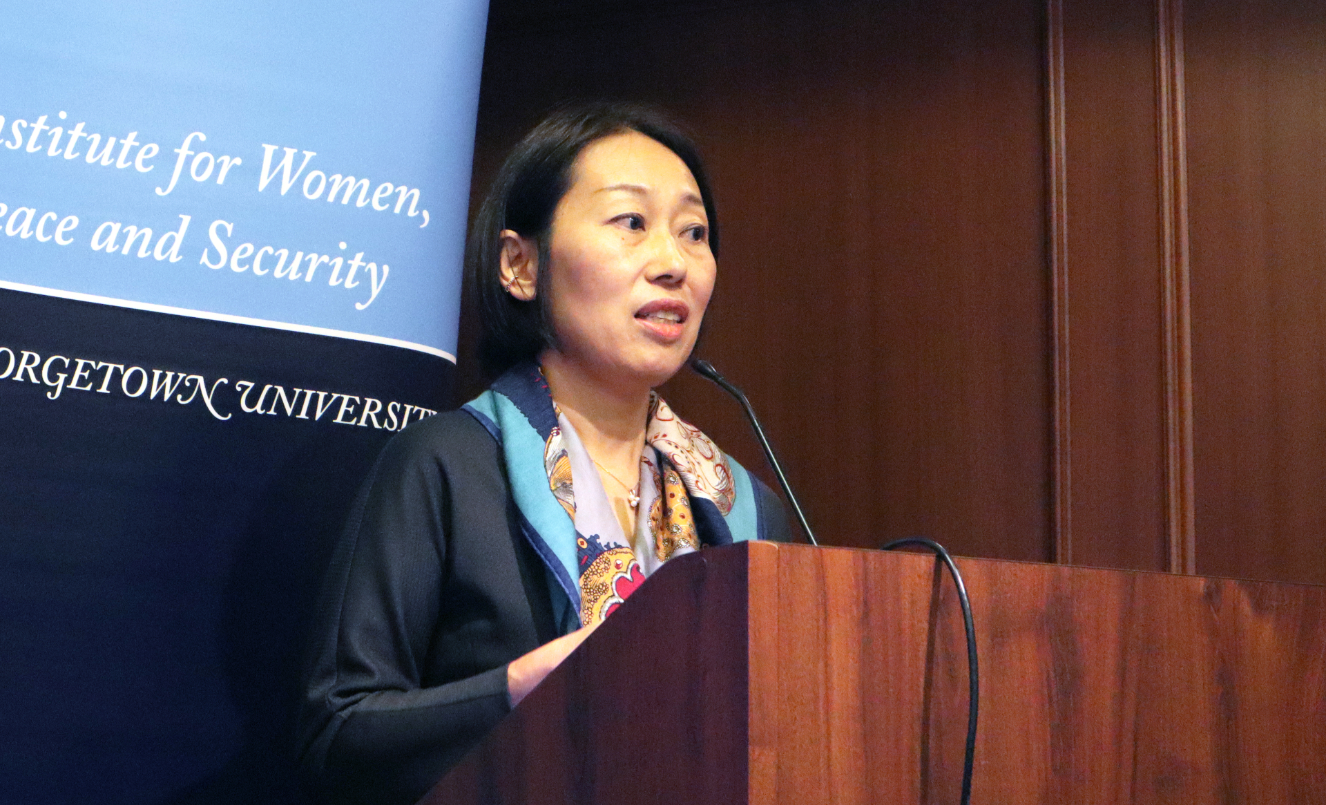 Ms. Nakayama at a podium