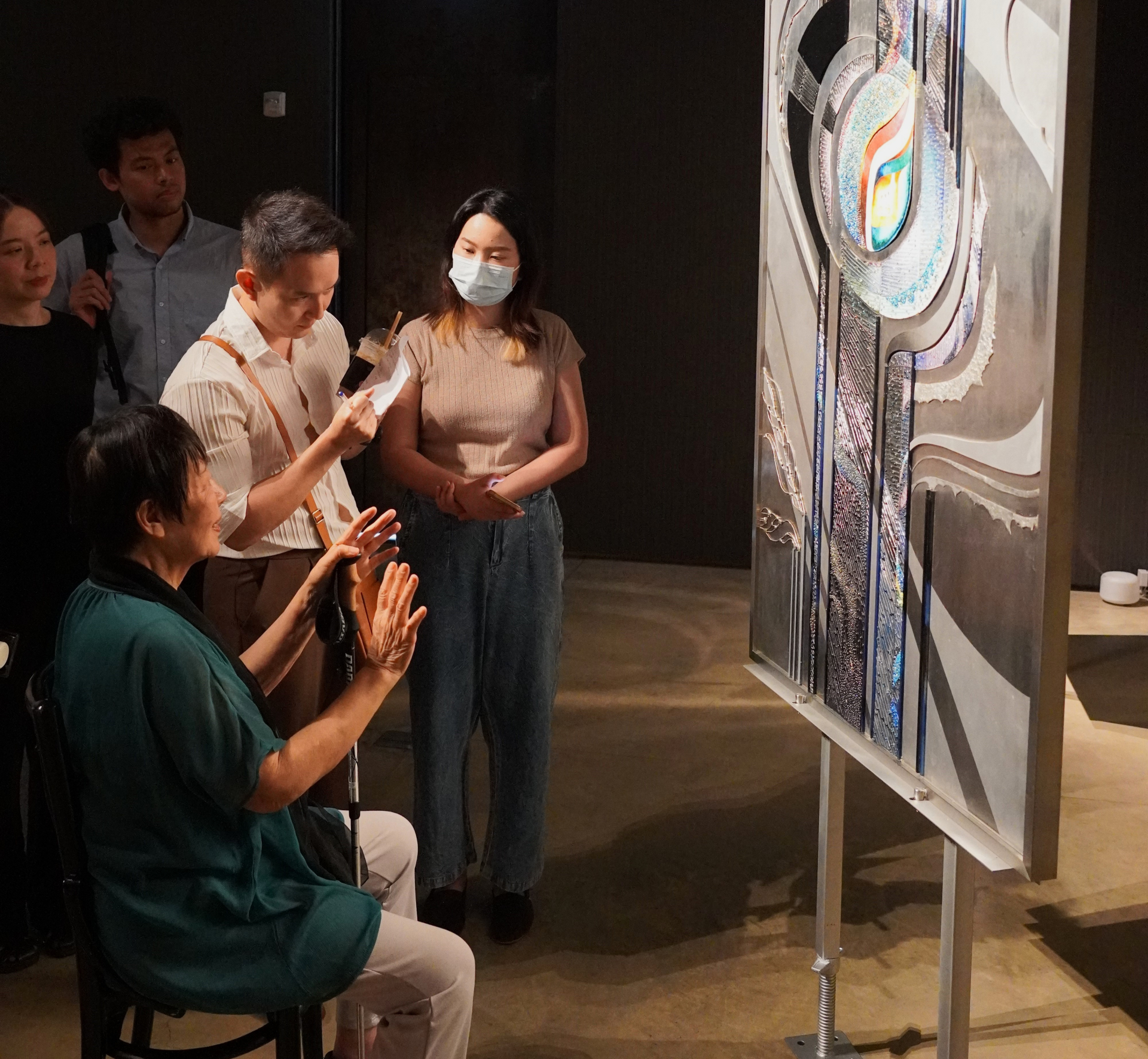 Ms. Tanaka being interviewed by a local journalist on the first day of the exhibition.